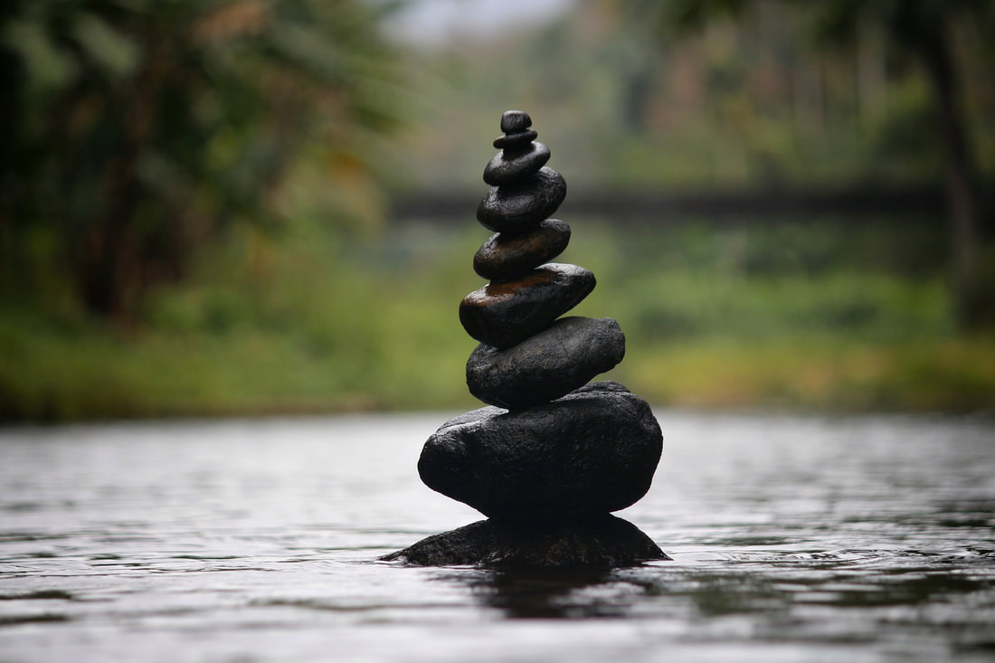 Picture of river stones stacked into a short tower balancing on each other